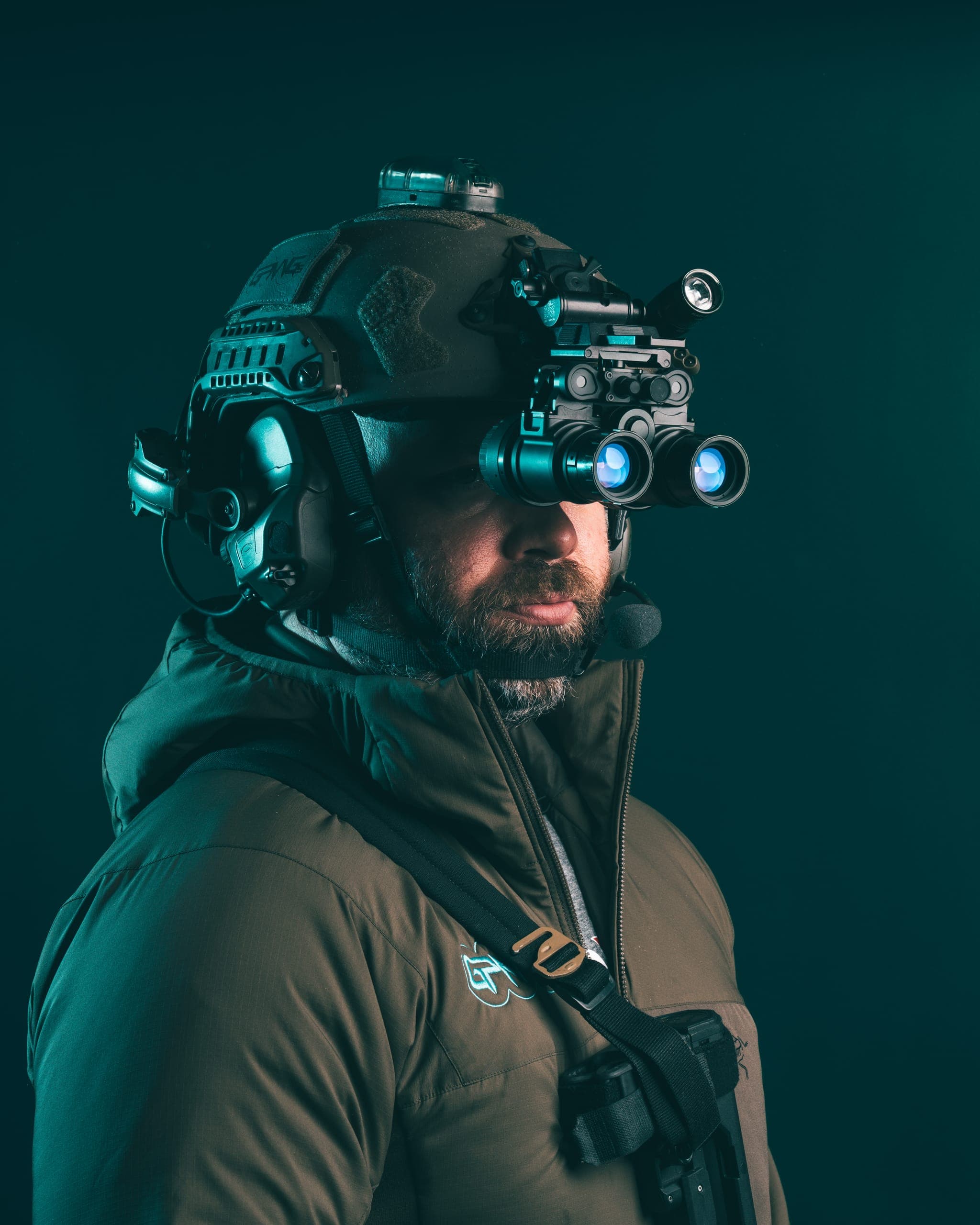 Night vision enthusiast using quad-tube goggles outdoors